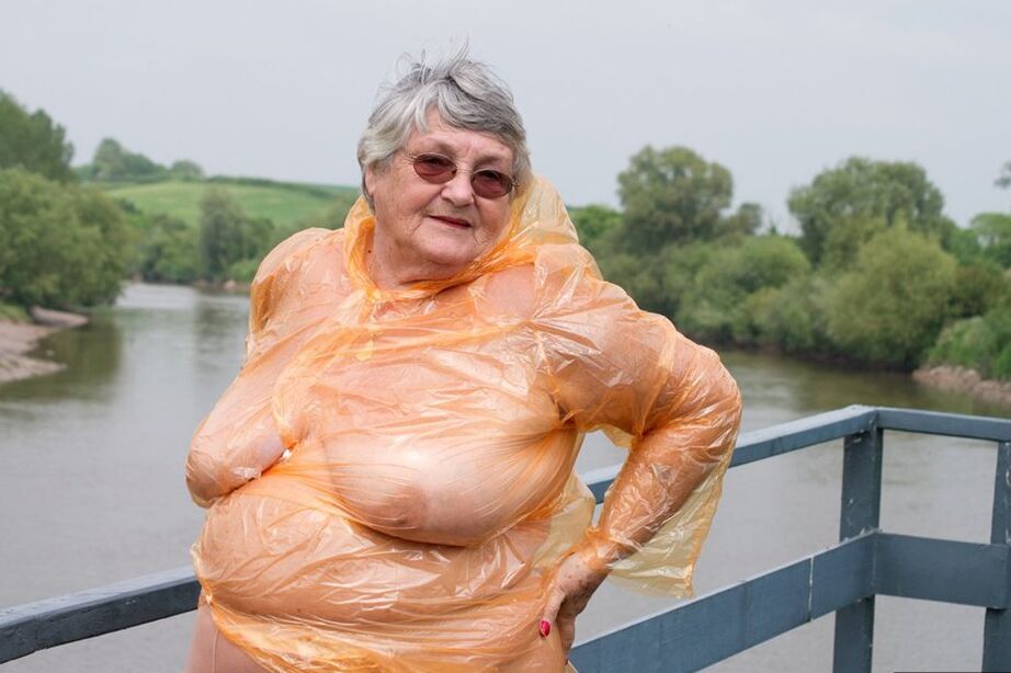 20P Obese oma Grandma Libby doffs a see-through raincoat to get naked on a bridge
