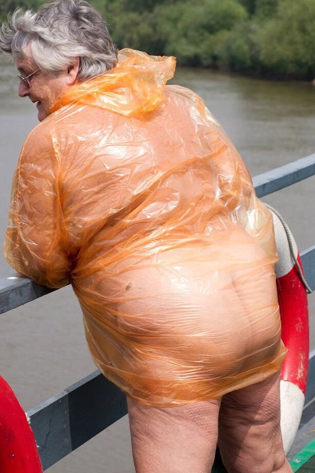 20P Obese oma Grandma Libby doffs a see-through raincoat to get naked on a bridge