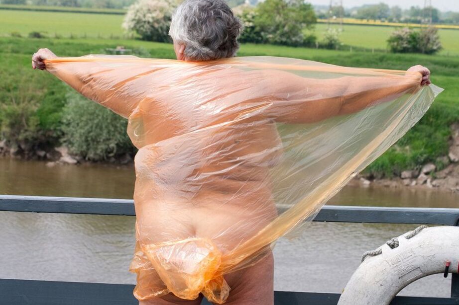 20P Obese oma Grandma Libby doffs a see-through raincoat to get naked on a bridge