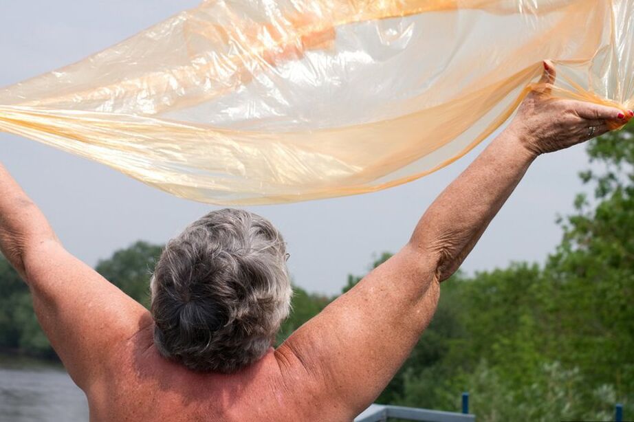 20P Obese oma Grandma Libby doffs a see-through raincoat to get naked on a bridge