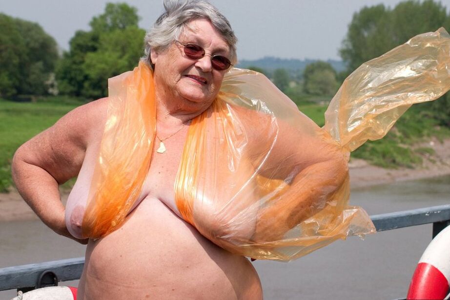 20P Obese oma Grandma Libby doffs a see-through raincoat to get naked on a bridge