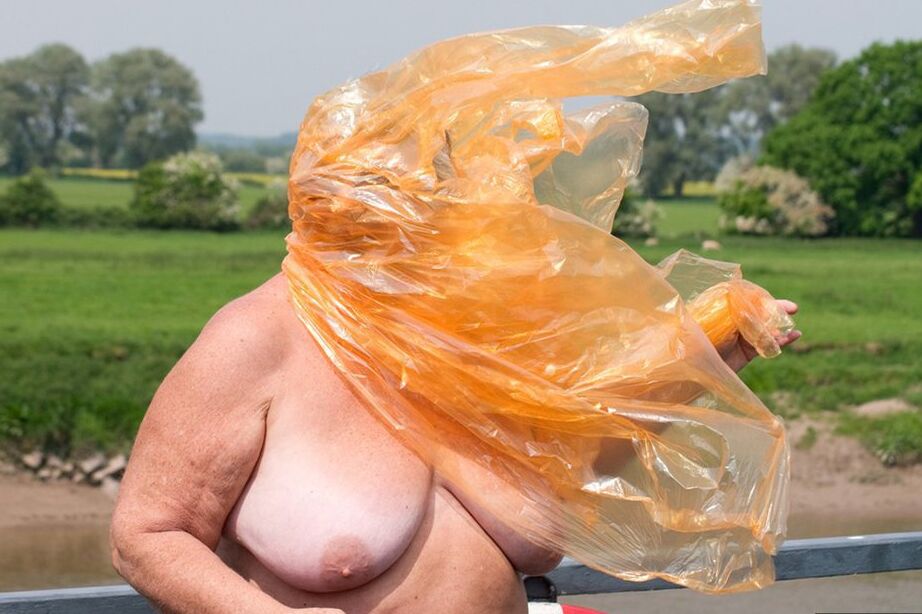 20P Obese oma Grandma Libby doffs a see-through raincoat to get naked on a bridge