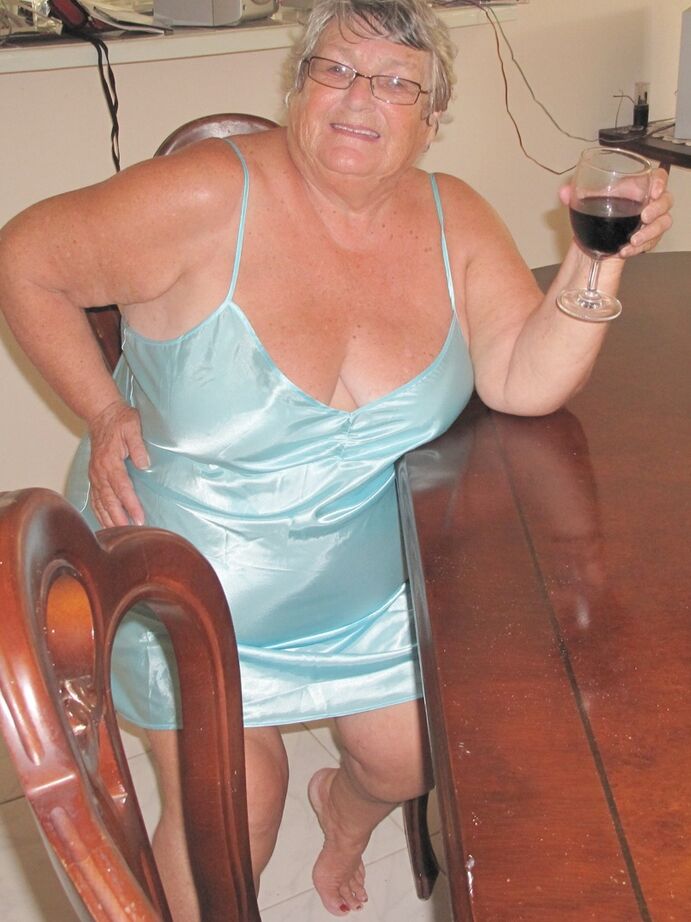 20P Old British fatty Grandma Libby sticks in a wine bottle in her cunt on a table