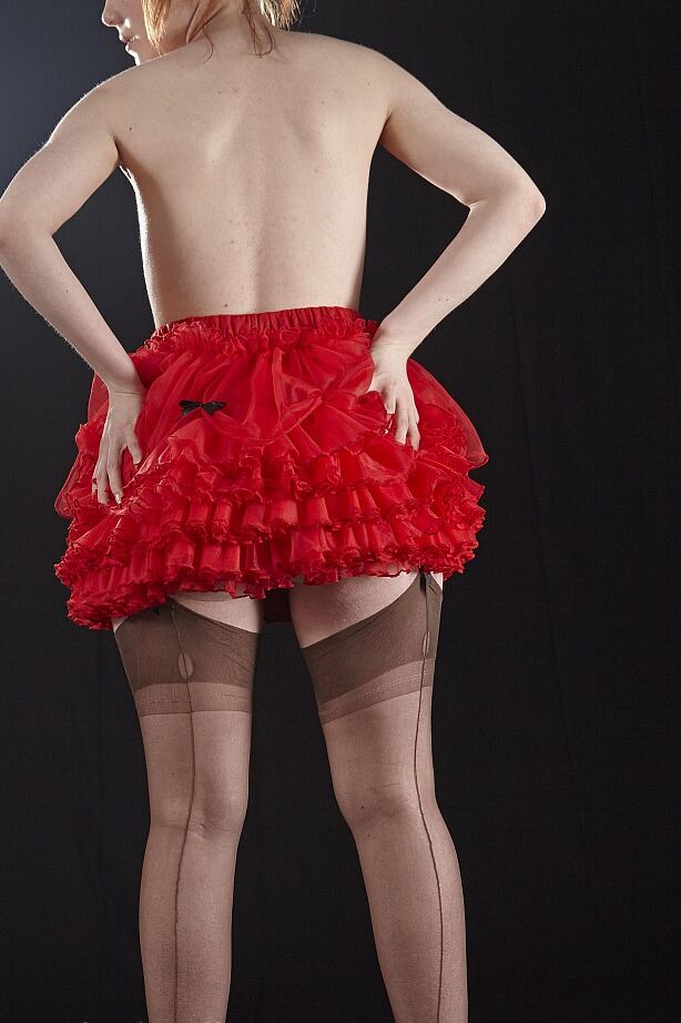 15P Natural redhead Ella Hughes models topless in a red tutu paired with FF nylons