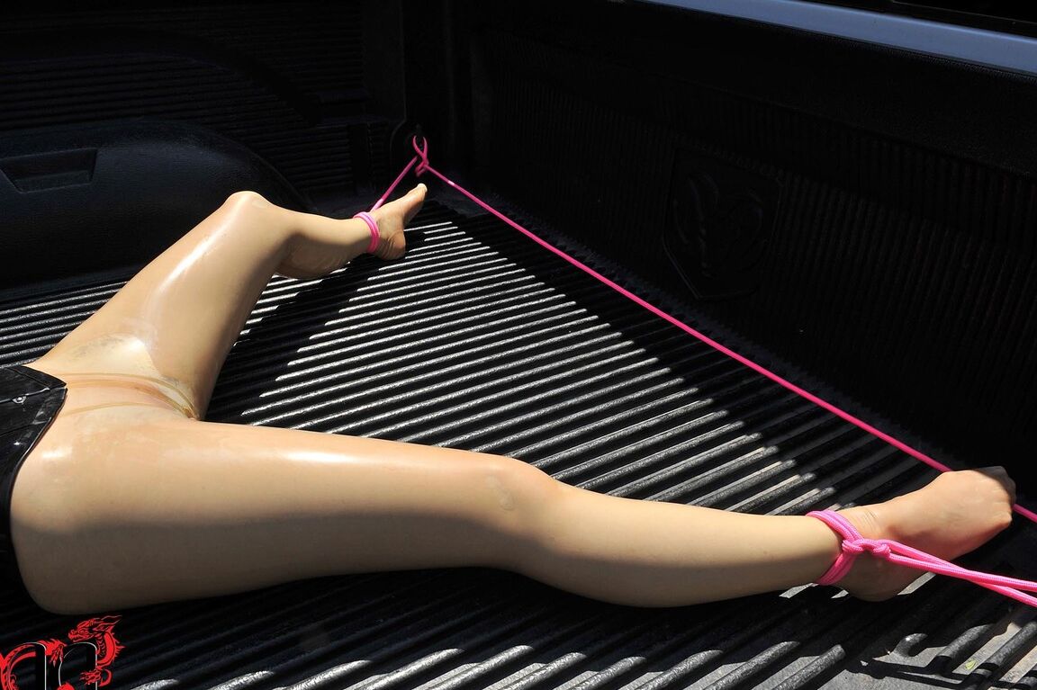 21P British girl in latex Latex Lucy gets tied on a truck & water jetted in BDSM