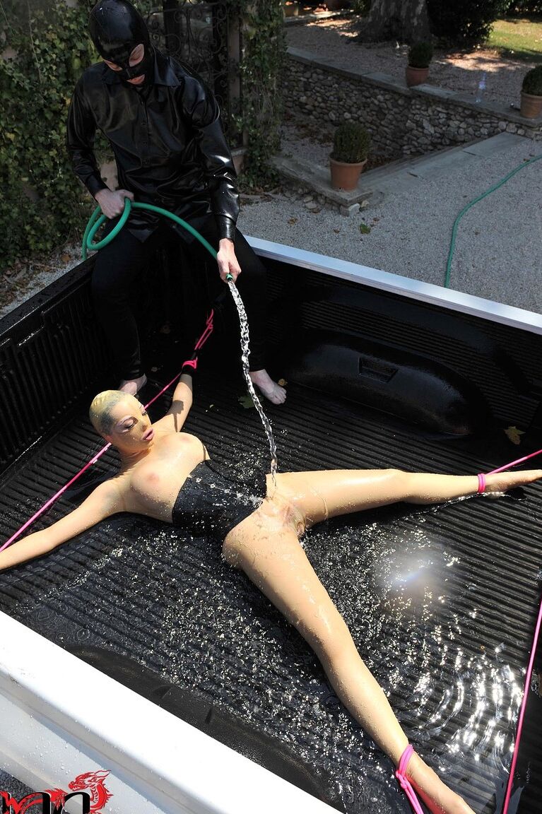 21P British girl in latex Latex Lucy gets tied on a truck & water jetted in BDSM