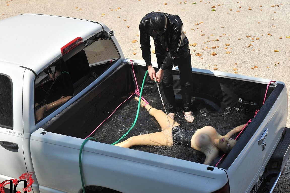 21P British girl in latex Latex Lucy gets tied on a truck & water jetted in BDSM