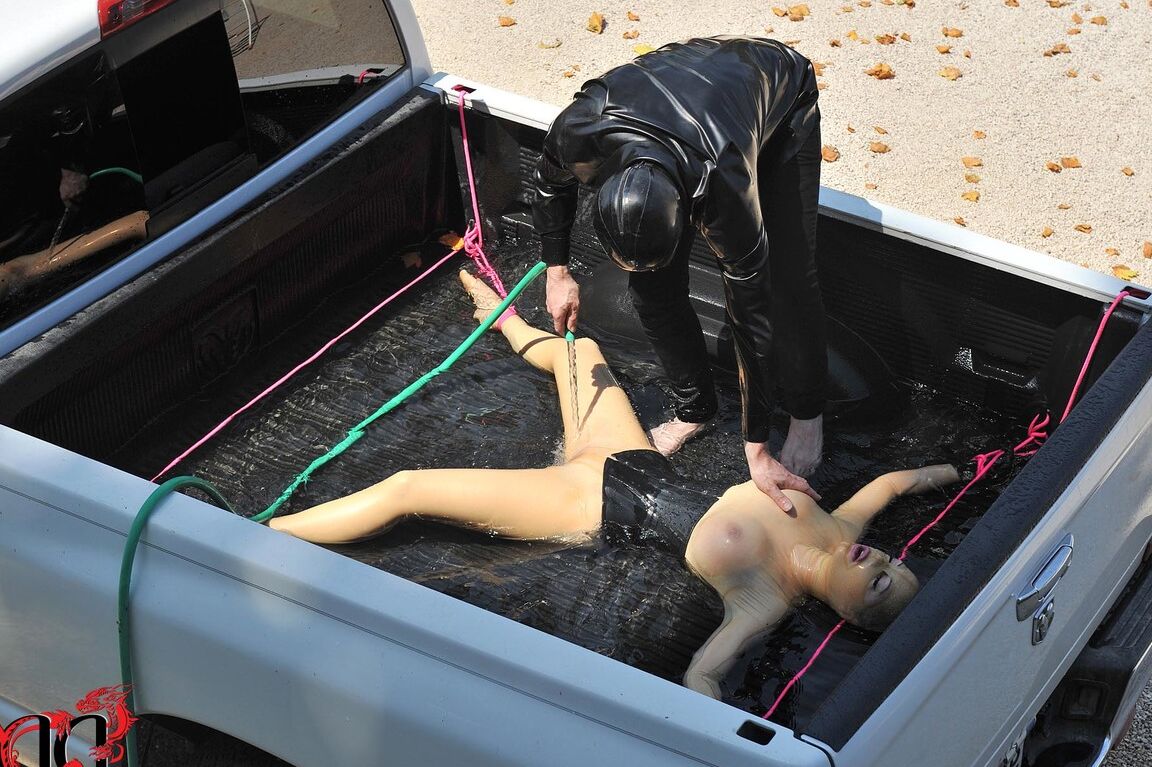 21P British girl in latex Latex Lucy gets tied on a truck & water jetted in BDSM