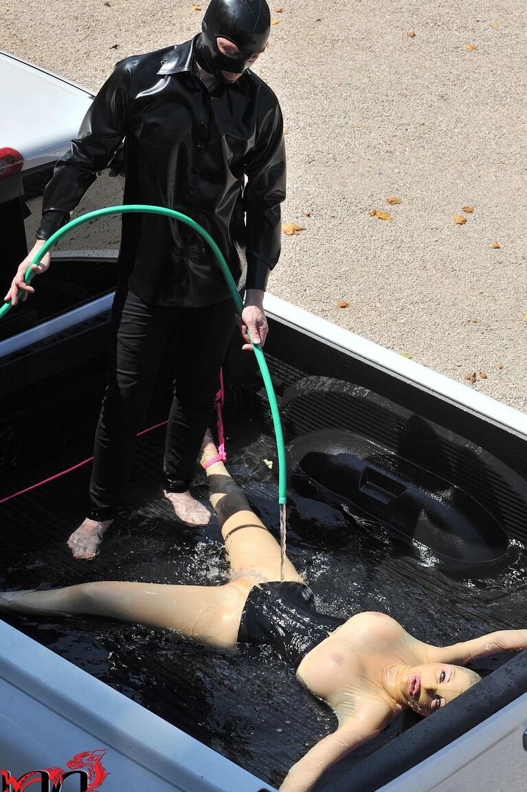 21P British girl in latex Latex Lucy gets tied on a truck & water jetted in BDSM
