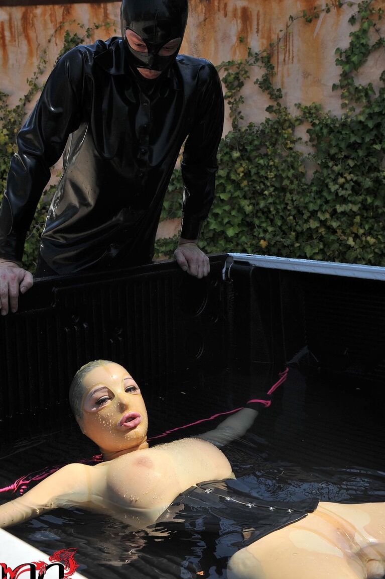 21P British girl in latex Latex Lucy gets tied on a truck & water jetted in BDSM