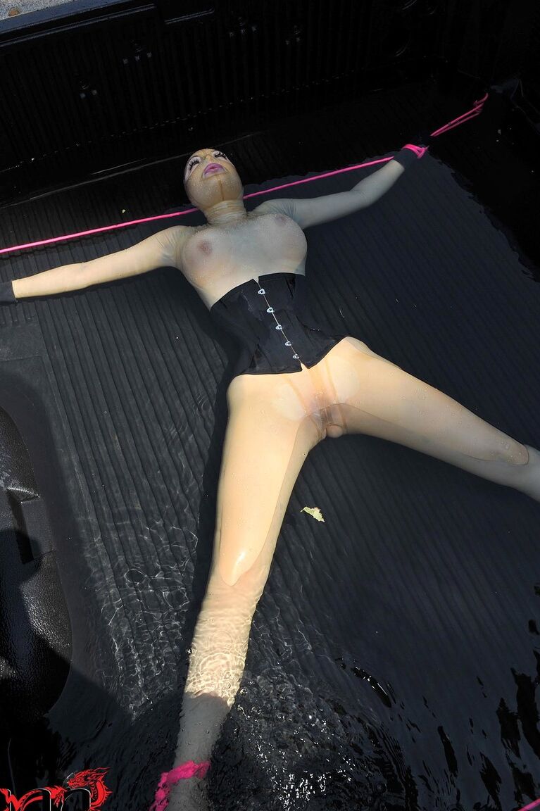 21P British girl in latex Latex Lucy gets tied on a truck & water jetted in BDSM