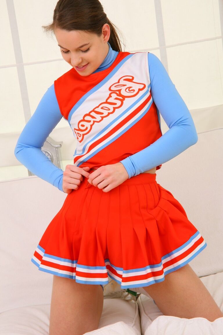 21P Teenage cheerleader Michaela loses uniform and poses in cute white panties
