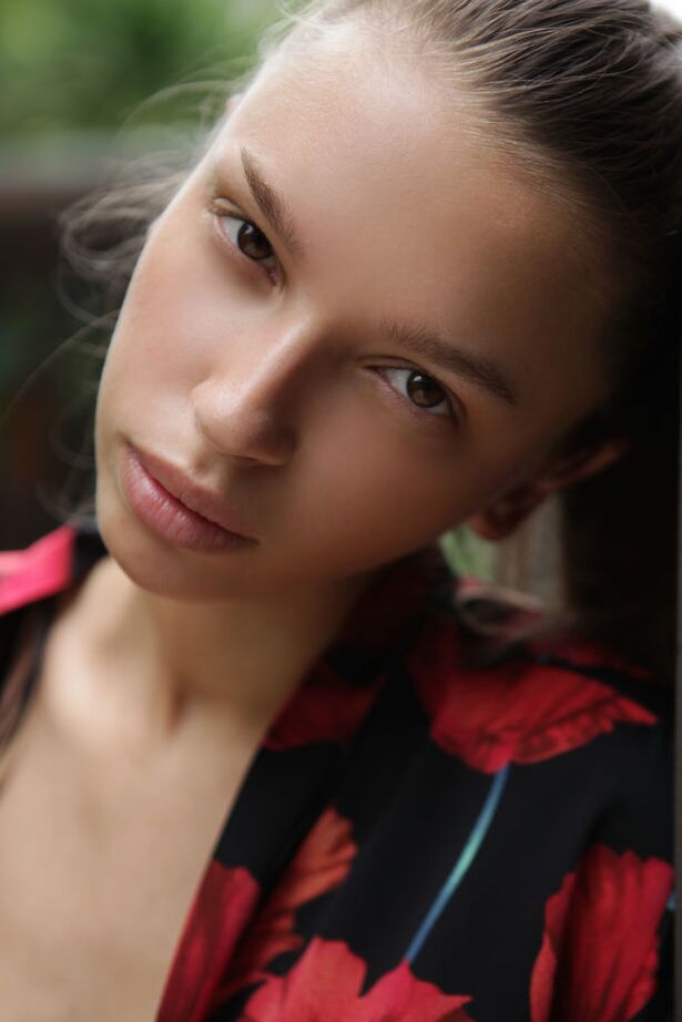 18P Slim teen Elin casts sultry looks while modeling naked on a deck