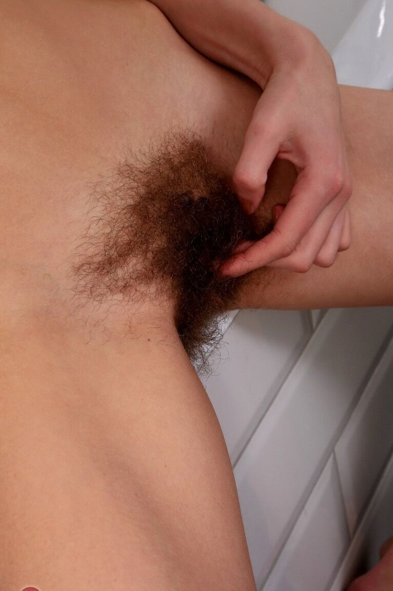 21P Brunette with small tits plays with her hairy beaver and masturbates in a tub