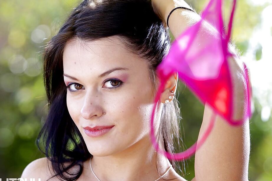 16P Dark haired solo girl Nadia Capri shedding pink teddy on lounge chair in yard