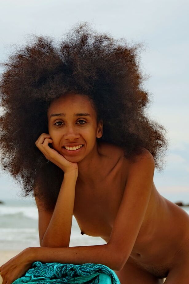 16P La delgada joven negra con mucho cabello Isadora muestra su culo caliente desnuda en una playa