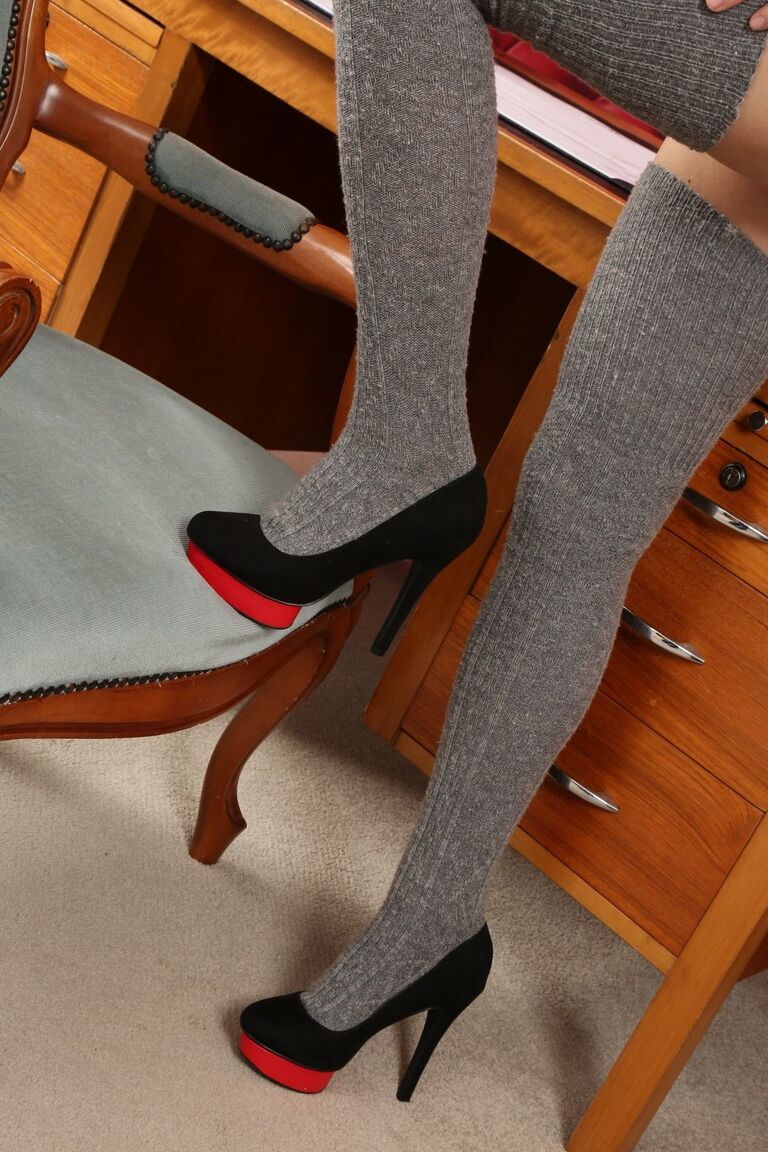 21P Innocent babe Celeste posing at the office in sexy grey over-the-knee socks