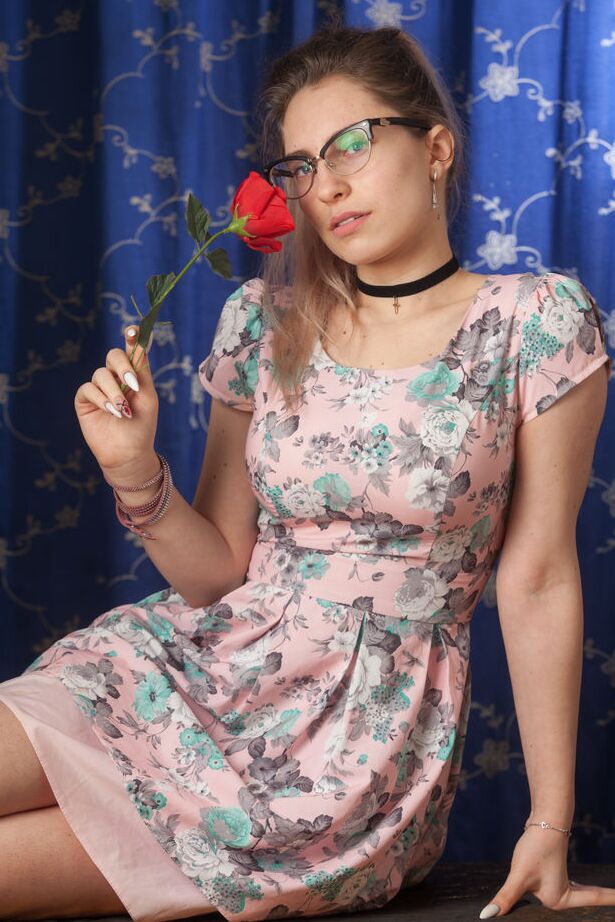 16P Nerdy 18 year old Liza Loo holds a rose showing her firm breasts in glasses
