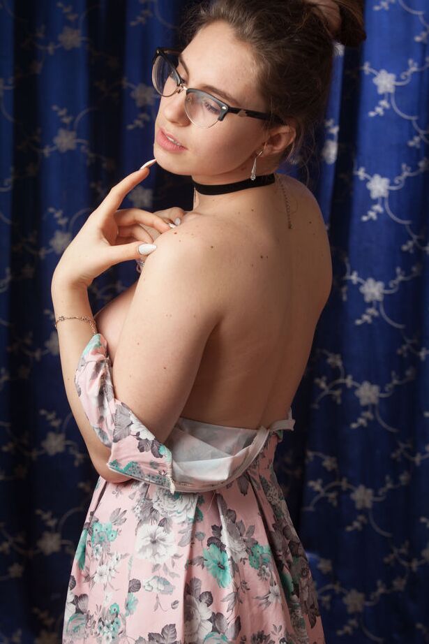 16P Nerdy 18 year old Liza Loo holds a rose showing her firm breasts in glasses