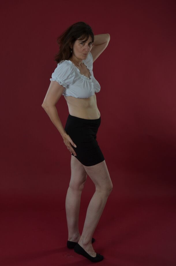 20P Amateur model uncovers saggy tits before sliding black miniskirt over bare ass