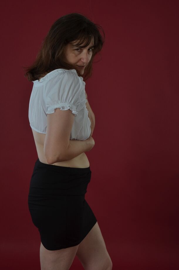 20P Amateur model uncovers saggy tits before sliding black miniskirt over bare ass