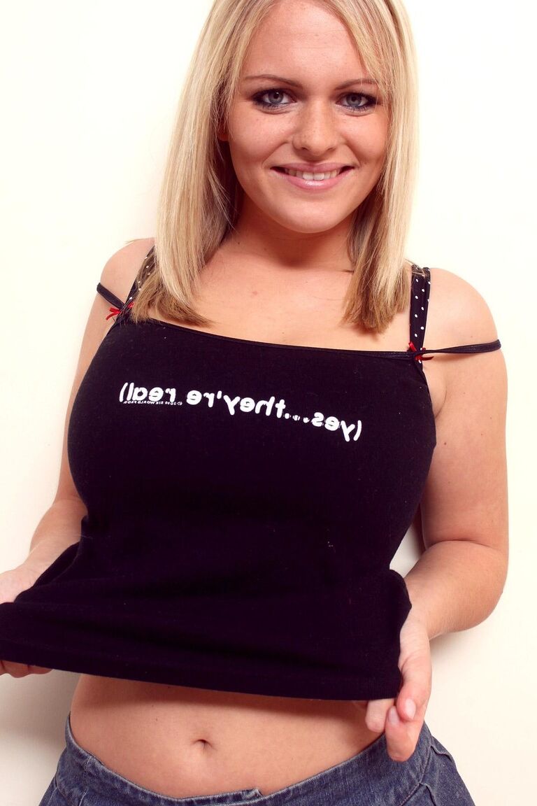 21P Blonde sweetie with big tits Charley flaunts her amazing attributes on a bed