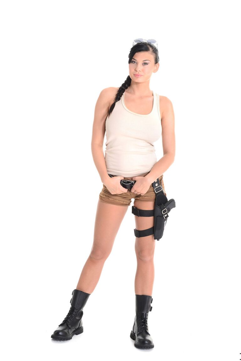 15P Busty brunette Lucy Li removes sidearm and shorts to pose nude in army boots