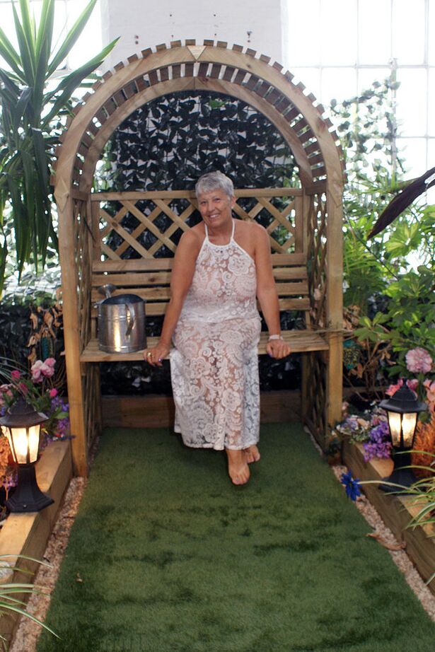 20P Hot granny Savana uncorks her giant breasts while attending to garden