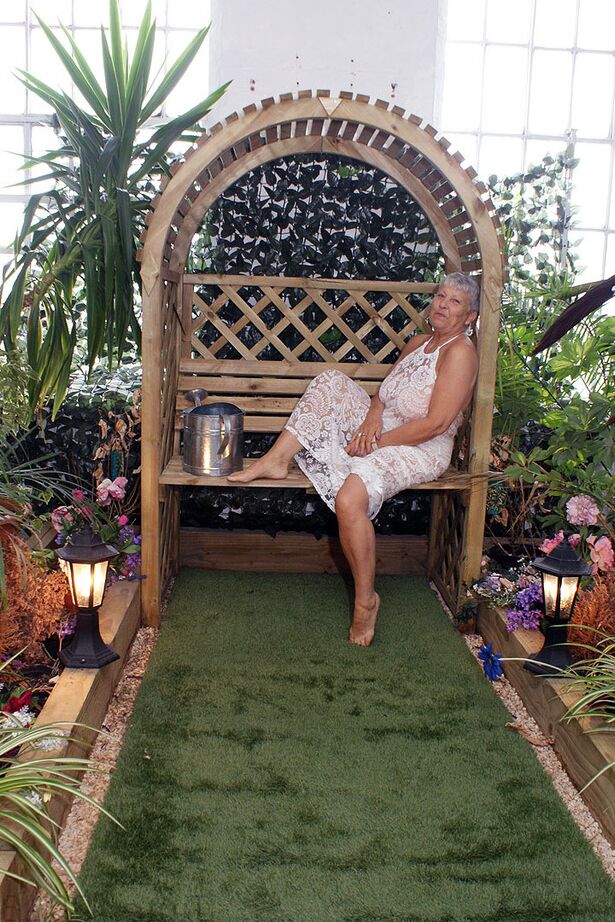 20P Hot granny Savana uncorks her giant breasts while attending to garden