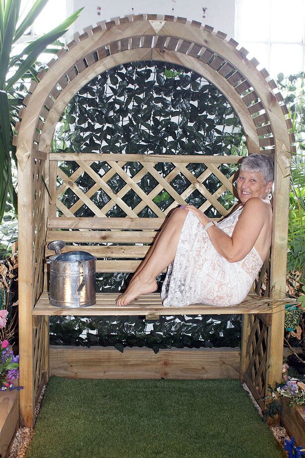 20P Hot granny Savana uncorks her giant breasts while attending to garden