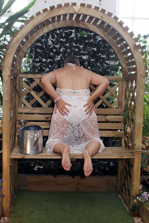 20P Hot granny Savana uncorks her giant breasts while attending to garden