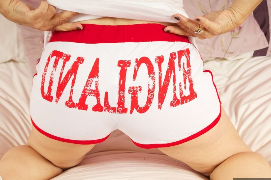 20P Short-haired nan Savana gets naked on a bed with panties around stiletto heels