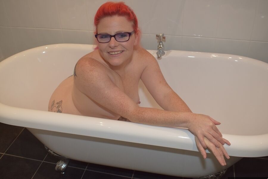 16P Tattooed redhead Mollie Foxxx models completely naked in a bathroom