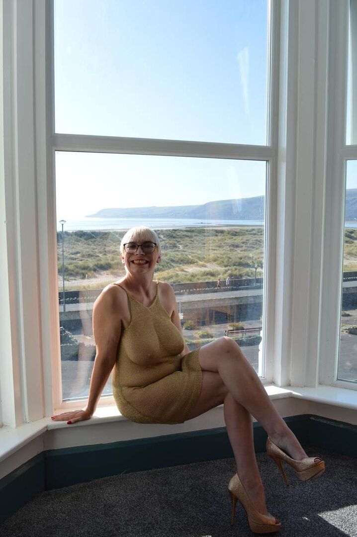 16P Big titted older woman Barby Slut showcases her bald twat in front of a window