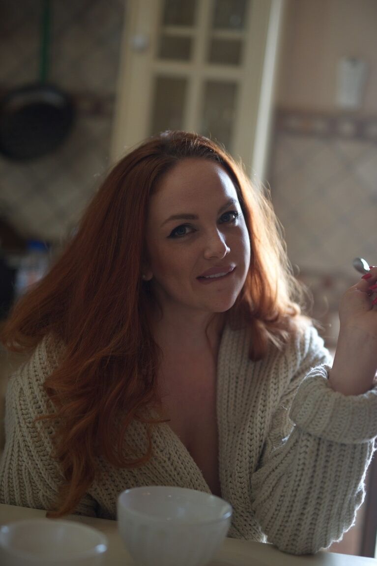 12P Redhead glam model Kara Carter rubs cream into her big natural tits
