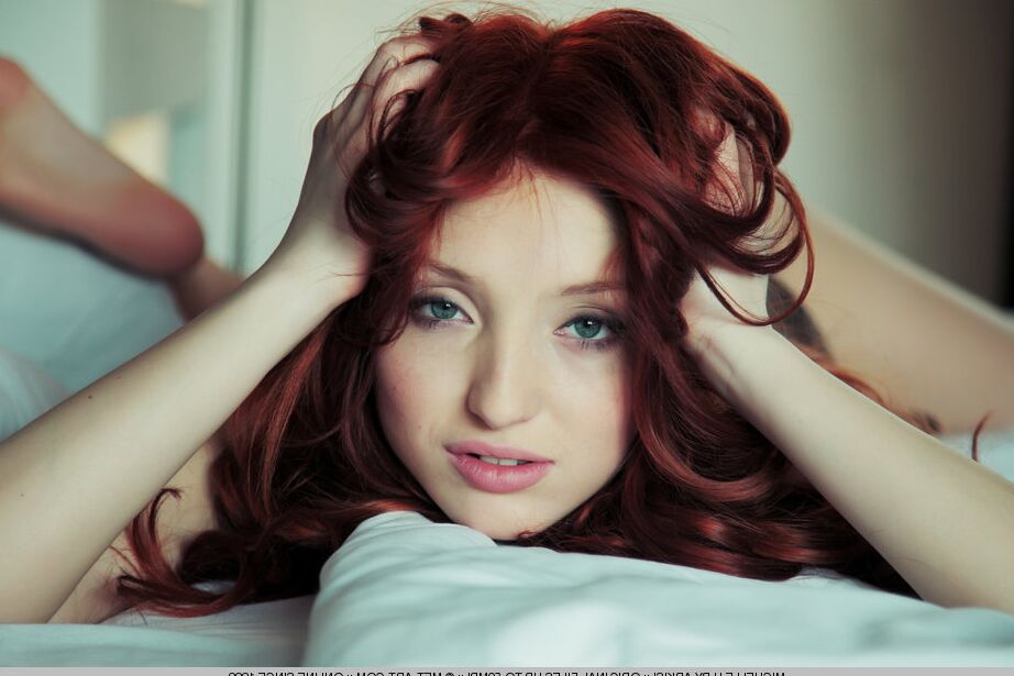 18P Young redhead Michelle H touting large breasts and shaved vagina