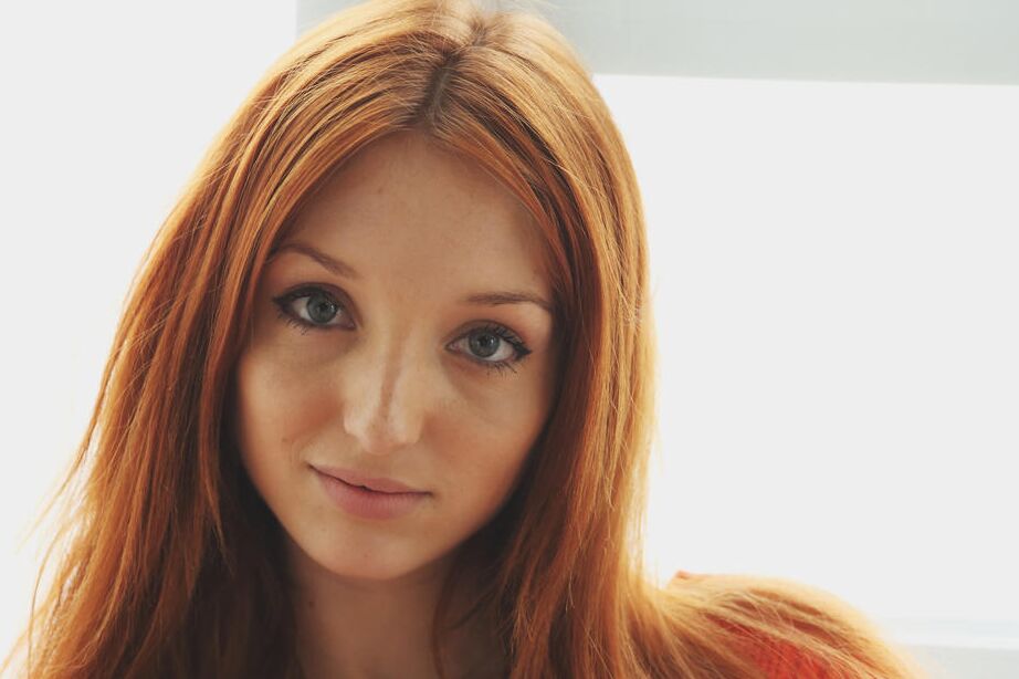 16P Beautiful ginger Micca shows her goodies while posing on the chair