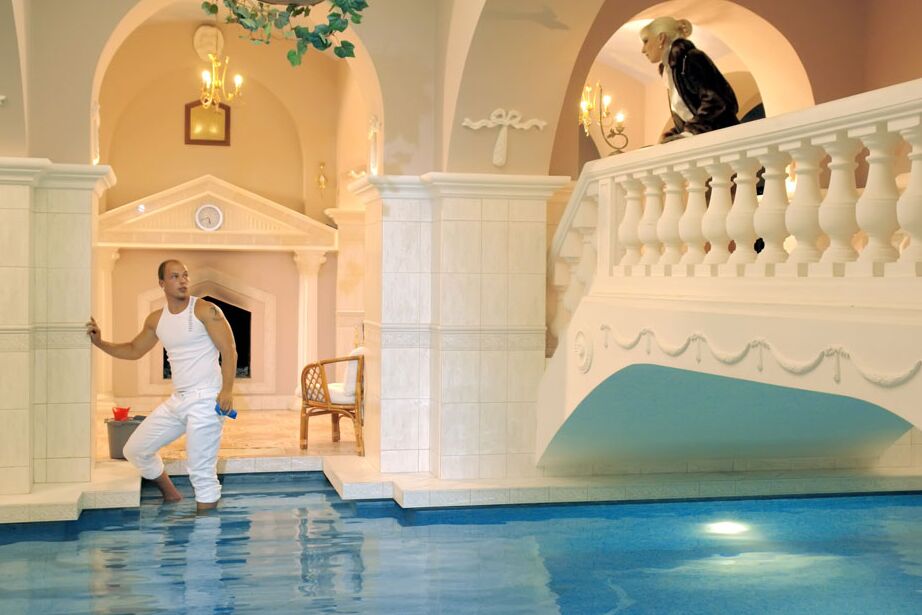 15P Fully clothed blonde wades into an indoor pool for hardcore sex with the help
