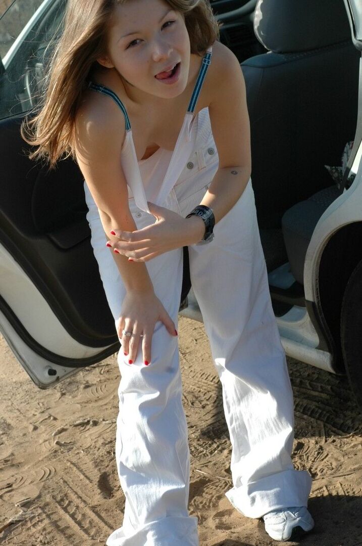 15P Emily posing in her car in the middle of the desert