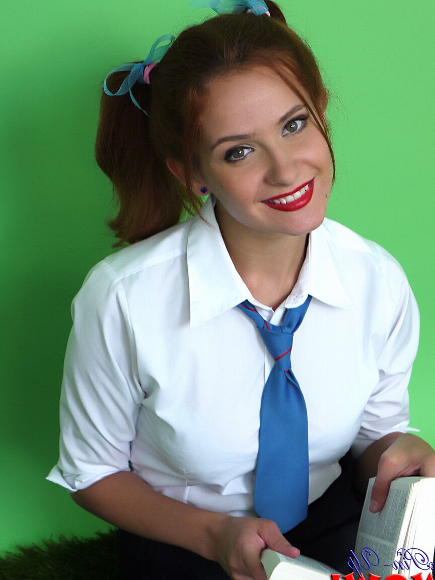 17P Cute redhead Elle Richie licks a lollipop before freeing big tits from uniform