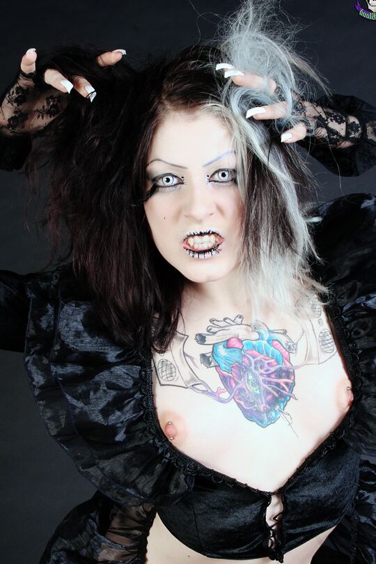 15P Goth girl Mad Sophie sports the Vampire look while exposing herself