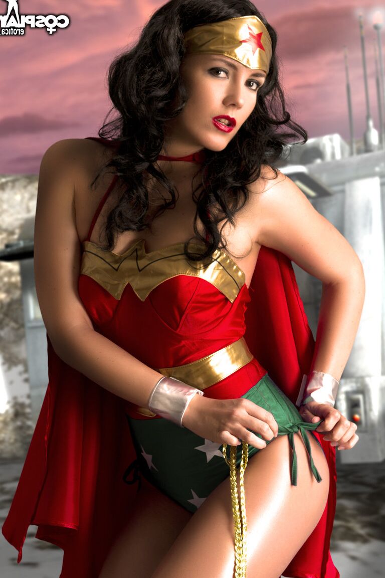 12P Beautiful brunette peels off her Wonder Woman outfit in a tempting manner