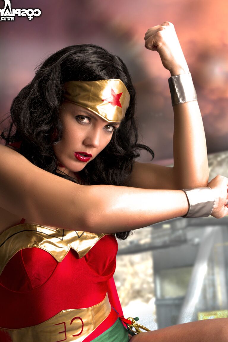 12P Beautiful brunette peels off her Wonder Woman outfit in a tempting manner
