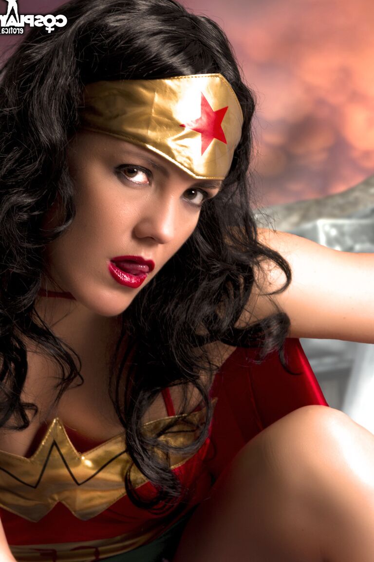 12P Beautiful brunette peels off her Wonder Woman outfit in a tempting manner
