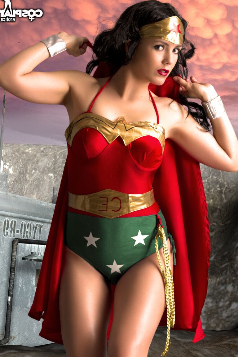 12P Beautiful brunette peels off her Wonder Woman outfit in a tempting manner