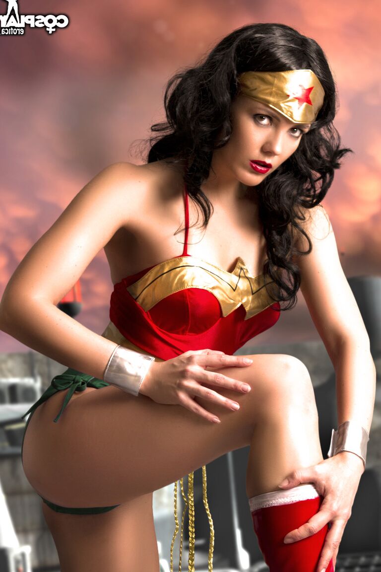 12P Beautiful brunette peels off her Wonder Woman outfit in a tempting manner