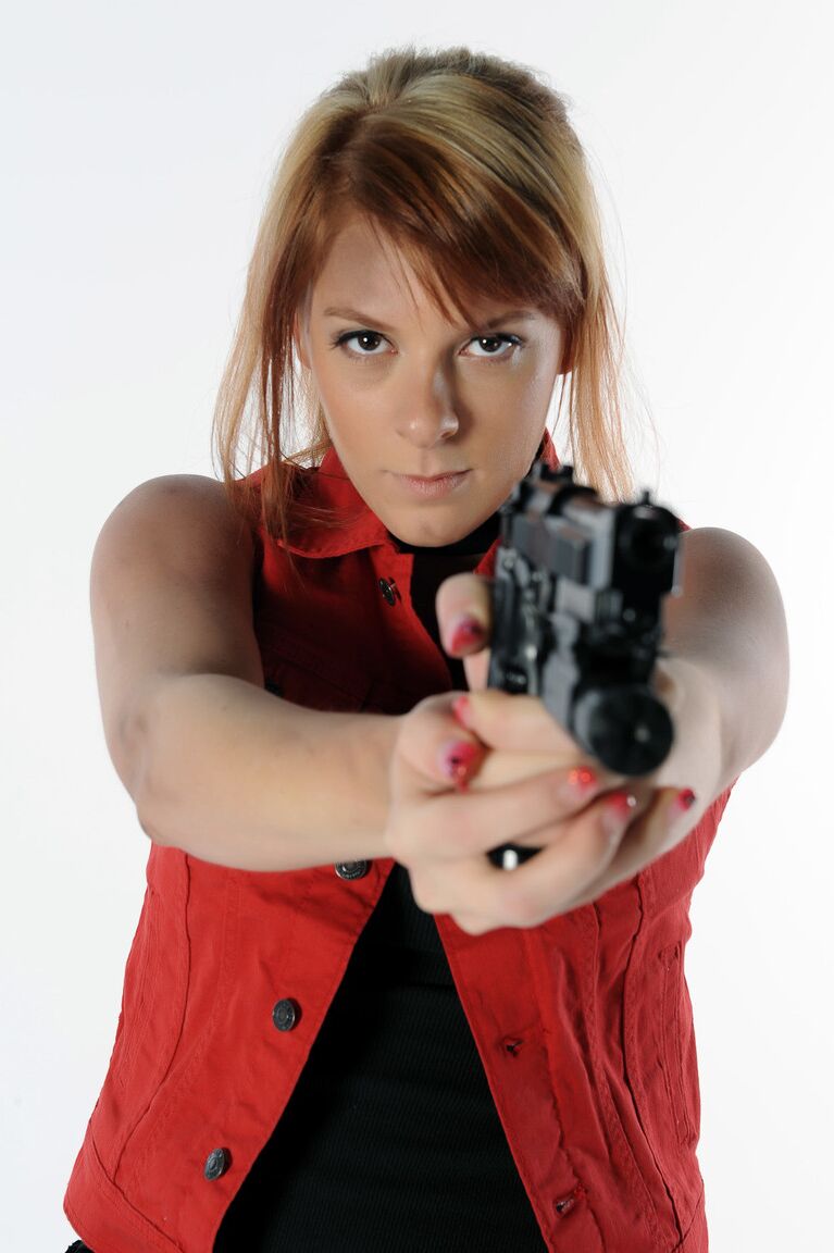 11P Solo girl Sophie wields a pistol while stripping to black boots