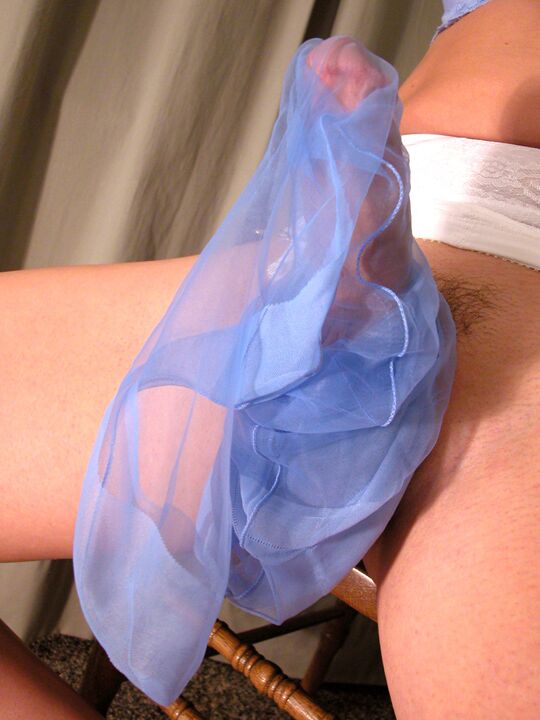 17P Delia in a tight white girdle stroking herself with blue stockings