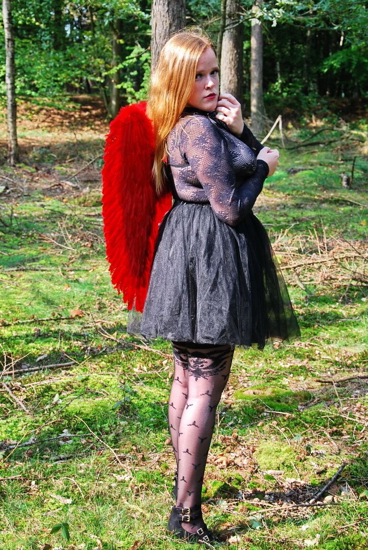 20P Une fille solo amateur arbore des ailes d'ange tout en modélisant de la lingerie sur une souche d'arbre