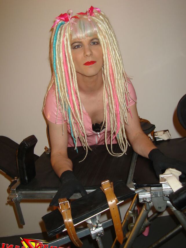 15P Naughty crazy haired crossdresser wearing pink pvc gets ready to go on the